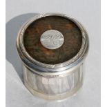 A silver mounted and tortoiseshell glass dressing table jar, London 1912, 6cms (2.25ins) high.