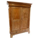 A French fruitwood and pine armoire, the pair of panelled doors above two short drawers, 149cms (