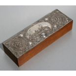 An Edwardian silver mounted oak glove box, Birmingham 1908, the top decorated in relief with a
