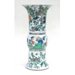 A large Chinese famille rose Gu vase decorated with flowering foliage and birds, 46cms (18ins)