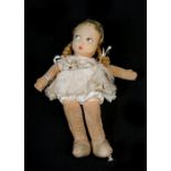 A Laura Wellings felt doll, 22cms (8.75ins) high.