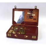 An Italian red leather travelling vanity case retailed by Liberty, 30cms (12ins) wide.Condition