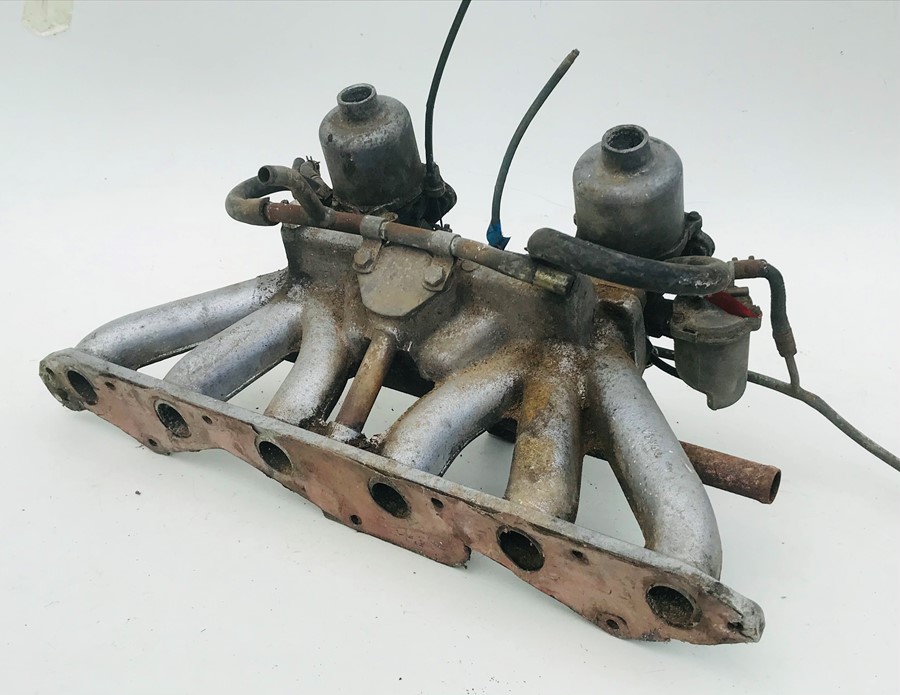 A pair of SU carburettors,mounted on a 6 cylinder manifold, possibly for a Rover