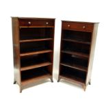 A matched pair of Regency open bookcases, each with single frieze drawer having lion mask handles,
