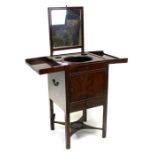 A Georgian mahogany gentleman's washstand, the folding top enclosing a fitted interior with a rise-