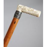 A late Victorian ivory handled walking cane, the handle with a cylindrical section, on one side