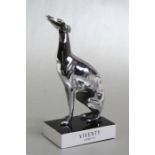 A large and impressive chrome plated seated greyhound accessory mascot / statue, mounted on a