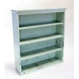 A distressed painted open bookcase, 99cms (39ins) wide.