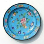 An 18th / 19th century Chinese enamel shallow dish decorated with flowers on a blue ground, 32cms (