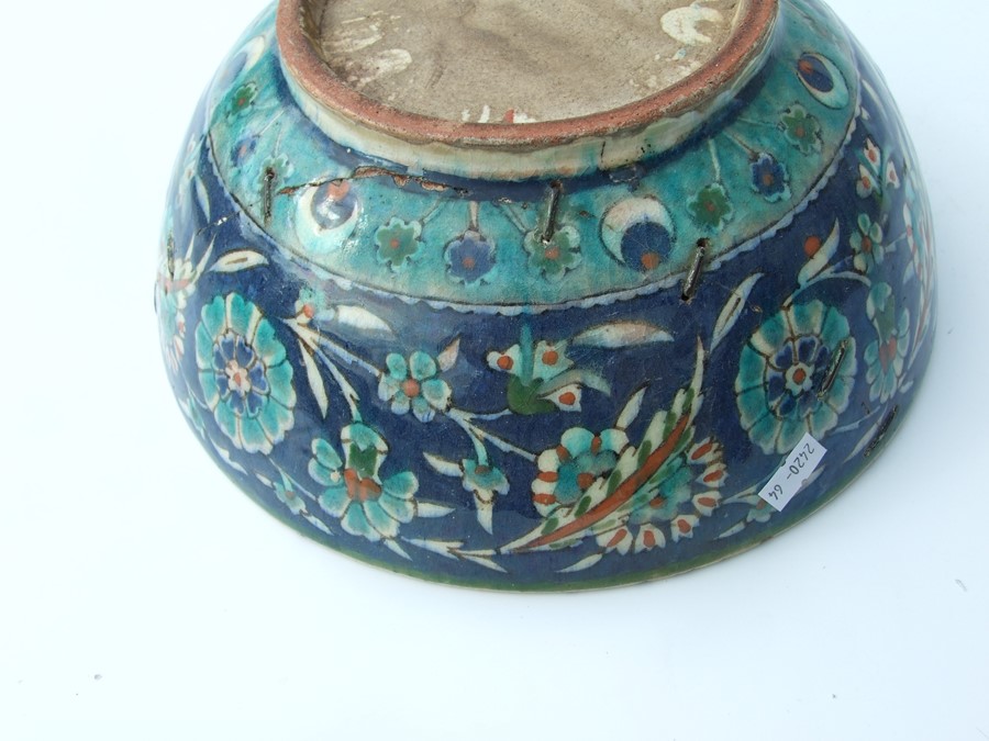 An Iznik pottery bowl decorated with flowers on a green ground, 27cms (10.5ins) diameter; together - Image 16 of 17