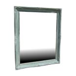 A large distressed painted bevel edged wall mirror, overall 110 by 141cms (43.25 by 55.5ins).