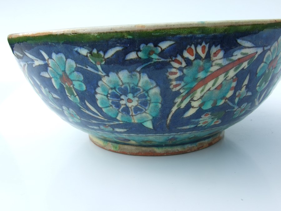 An Iznik pottery bowl decorated with flowers on a green ground, 27cms (10.5ins) diameter; together - Image 4 of 17