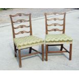 A pair of Georgian mahogany chairs with over stuff over seats, on square chamfered front supports (