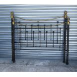 A modern Victorian style brass and painted metal king size bed.