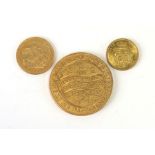 A collection of three gold coloured coins with Charles I, George III and Queen Victoria heads (3).