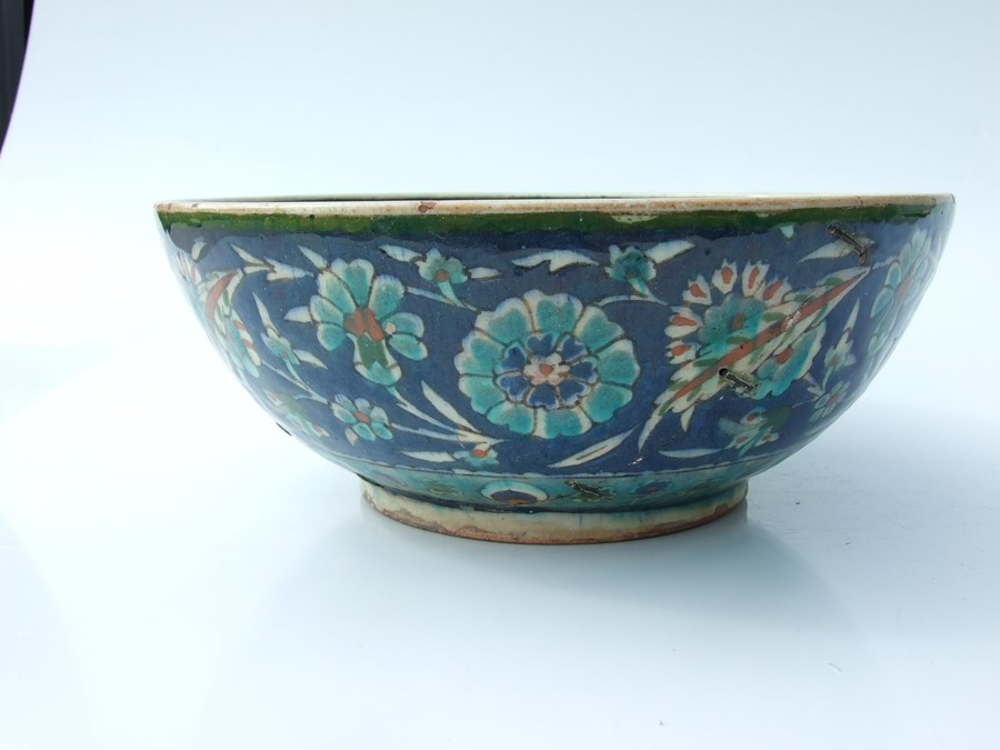 An Iznik pottery bowl decorated with flowers on a green ground, 27cms (10.5ins) diameter; together - Image 2 of 17