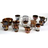 A quantity of copper lustre ware to include jugs, bowls and goblets.