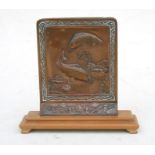 A Japanese copper plaque depicting Koi carp in a pond, mounted on a wooden stand with wax