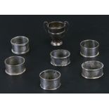 Six silver napkin rings, various dates and makers, all initialled; together with a small silver