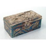 A Chinese white metal hardwood lined box decorated in relief with a dragon, 18cms (8ins) wide.