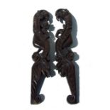 A pair of 18th / 19 century oak carvings in the form of stylised animals. 58cm (23 ins) high