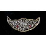 An Indian / Ottoman gilt metal brooch mounted with rough cut diamonds and two oval red stones,