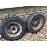 A pair of splined conical hubbed wire wheels, fitted with Firestone 6.00-16 inch Super Sports