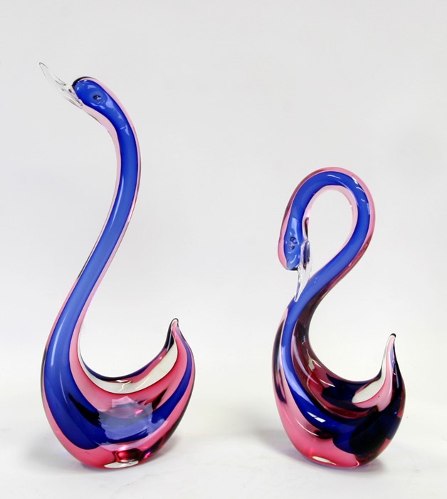 A Murano Sommerso glass swan, 16cms (4ins) high; together with another, 30cms (12ins) high (2).