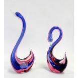 A Murano Sommerso glass swan, 16cms (4ins) high; together with another, 30cms (12ins) high (2).