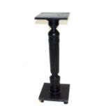 An ebonised plant stand on turned column, 71cms (27.75ins) high.