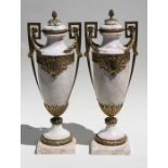 A large pair of marble urns with gilt metal mounts, 60cms (23.75ins) high.