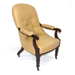 An early Victorian mahogany button back armchair with upholstered seat and back, on turned front