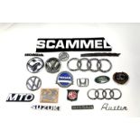 A large quantity of various marque bonnet insignias for various models including Volkswagen, Nissan,