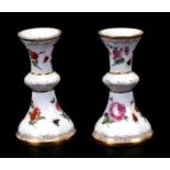 A pair of Meissen stands decorated with insects and flowers, 10cms (4ins) high (2).