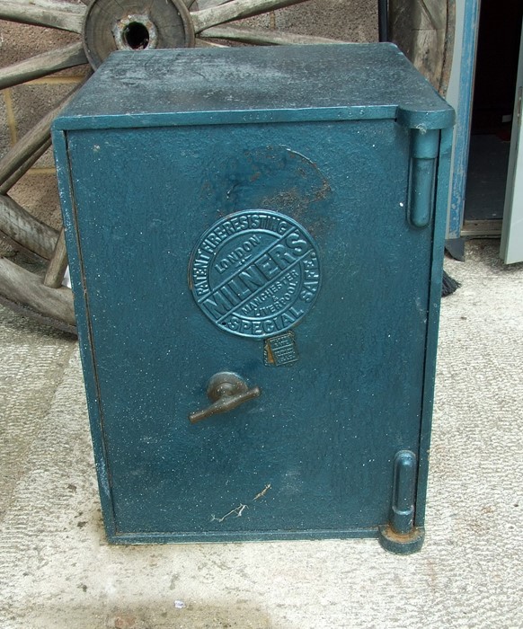 A Milner's free standing safe with key, 48.5 by 64cms (19 by 25ins).