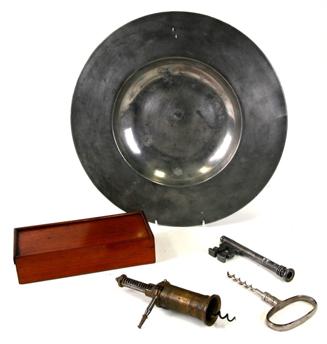 A pewter charger, 36cms (14ins) diameter; together with two corkscrews and a mahogany boxed set of