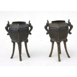 A pair of Japanese bronze censers on four elongated lion mask capped legs, 14cms (5.5ins) high (2).