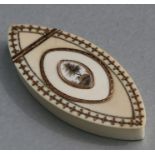 An 18th century ivory and yellow metal inlaid snuff box of navette form with central oval panel to