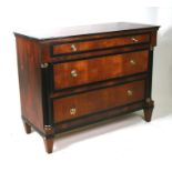 A Biedermeier style chest of three graduated long drawers flanked by ebonised pillars, 106cms (41.