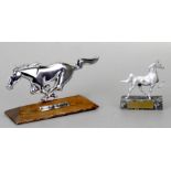 A Ford Mustang insignia mounted on a plinth, 20cms (8ins) wide and an Area's Division Mustang trophy