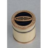 A late 18th century yellow metal mounted ivory box of cylindrical form, the blue enamel top with