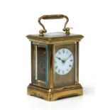A miniature four-pillar gilt brass carriage clock, the white enamel dial with Roman numerals,