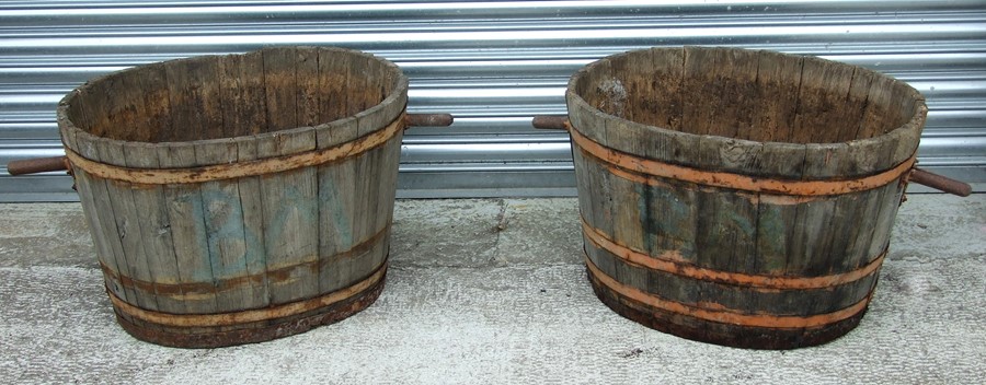 A pair of oval coopered barrels with handles, 69cms (27ins) diameter excluding handles (2).