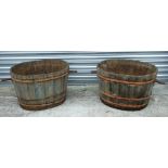 A pair of oval coopered barrels with handles, 69cms (27ins) diameter excluding handles (2).