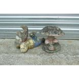 A painted stoneware garden gnome, 34cms (13.5ins) long; together with a stoneware toadstool group,