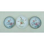 A pair of 18th century Chinese shallow dishes decorated with flowers, 14cms (5.5ins) diameter;