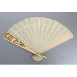 A 19th century Dieppe ivory brize fan, the guard deeply carved with scrolling flowers, 22cms (18.