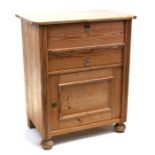 A continental stripped pine cupboard with two drawers above a cupboard, 67cms (26.5ins) wide.