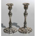 A pair of Edwardian George III style silver candlesticks with detachable sconces, Evans & Co.