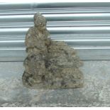 A well weathered reconstituted stone garden figure, 31cms (12.25ins) wide.